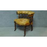 A late 19th century mahogany framed leather upholstered buttoned back library tub armchair on turned