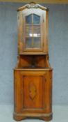 A Continental walnut carved corner cabinet raised on bracket feet. 204x71cm