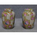 A pair of hand painted lidded crackle glaze ginger jars by Chinese porcelain maker Wong Lee. Painted