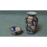 A hand painted oriental porcelain vase and fluted bowl. With gilded details and floral design. H.