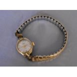 A vintage ladies gold plated hand wound Medana watch. White enamel dial with gold plated markers, on