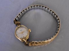 A vintage ladies gold plated hand wound Medana watch. White enamel dial with gold plated markers, on