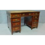A late 19th century mahogany pedestal desk with leather inset top above an arrangement of nine