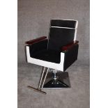 A retro style barber's chair with rise and fall and fully reclining action on chrome base. H.97 x