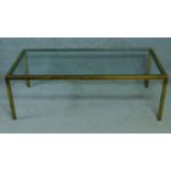 A vintage glass coffee table on brass frame. H.51 W.153 D.77cm