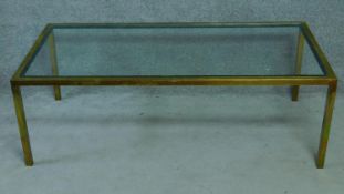 A vintage glass coffee table on brass frame. H.51 W.153 D.77cm