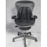 A contemporary Herman Miller Aeron ergonomic design office chair with reclining, swivelling and up