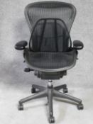 A contemporary Herman Miller Aeron ergonomic design office chair with reclining, swivelling and up