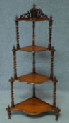 A Victorian carved walnut four tier corner whatnot. H.121cm