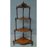 A Victorian carved walnut four tier corner whatnot. H.121cm