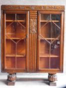 A mid 20th century Art Deco style oak bookcase fitted with astragal glazed doors. H.117 W.90 D.31cm