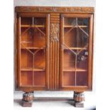 A mid 20th century Art Deco style oak bookcase fitted with astragal glazed doors. H.117 W.90 D.31cm