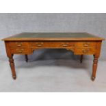 A Victorian walnut writing table with leather insert top and long central frieze drawer and four