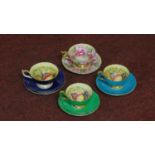 Four gilded Ainsley tea cups and saucers with fruit decoration along with one with rose flower