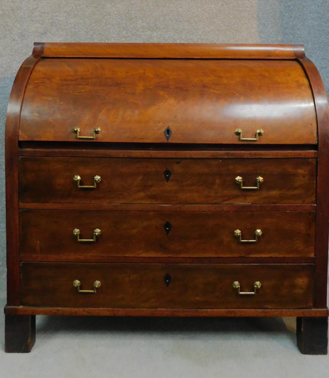 A 19th century continental mahogany cylinder top bureau with tooled leather lined slide out