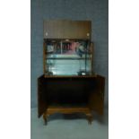 A Georgian style figured walnut cocktail cabinet fitted with mirrored interior raised on cabriole