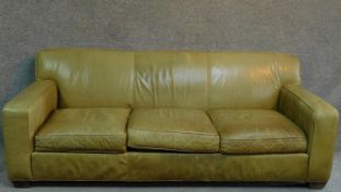 A pale green leather sofa raised on block feet. By Crate & Barrel. H.81 W.220 D.91cm