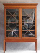 A Georgian style mahogany library bookcase with astragal glazed doors on square section supports.