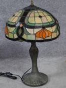 A Tiffany style iridescent stained glass table lamp. Shade has an Art Nouveau floral design with