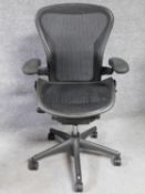 A contemporary Herman Miller Aeron ergonomic design office chair with reclining, swivelling and up