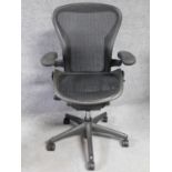 A contemporary Herman Miller Aeron ergonomic design office chair with reclining, swivelling and up