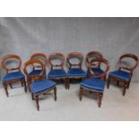 A set of eight Victorian mahogany balloon back dining chairs on turned tapering supports. H.91cm
