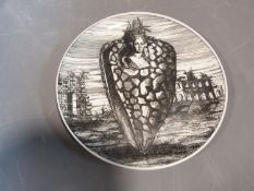 A black and white Fornasetti plate from the series Le Oceanidi, with a surrealist design of a bust