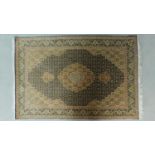 A Tabriz rug with central double pendant medallion with repeating petal motifs , complemented by a