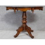 A Continental birch centre table on quadruped pedestal base. H.78 W.100 D.58cm