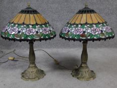 A pair of Tiffany style coloured glass table lamps. Shades have rose and foliate design and the