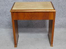 An Art Deco figured walnut piano stool with hinged lift up top enclosing sheet music compartment.