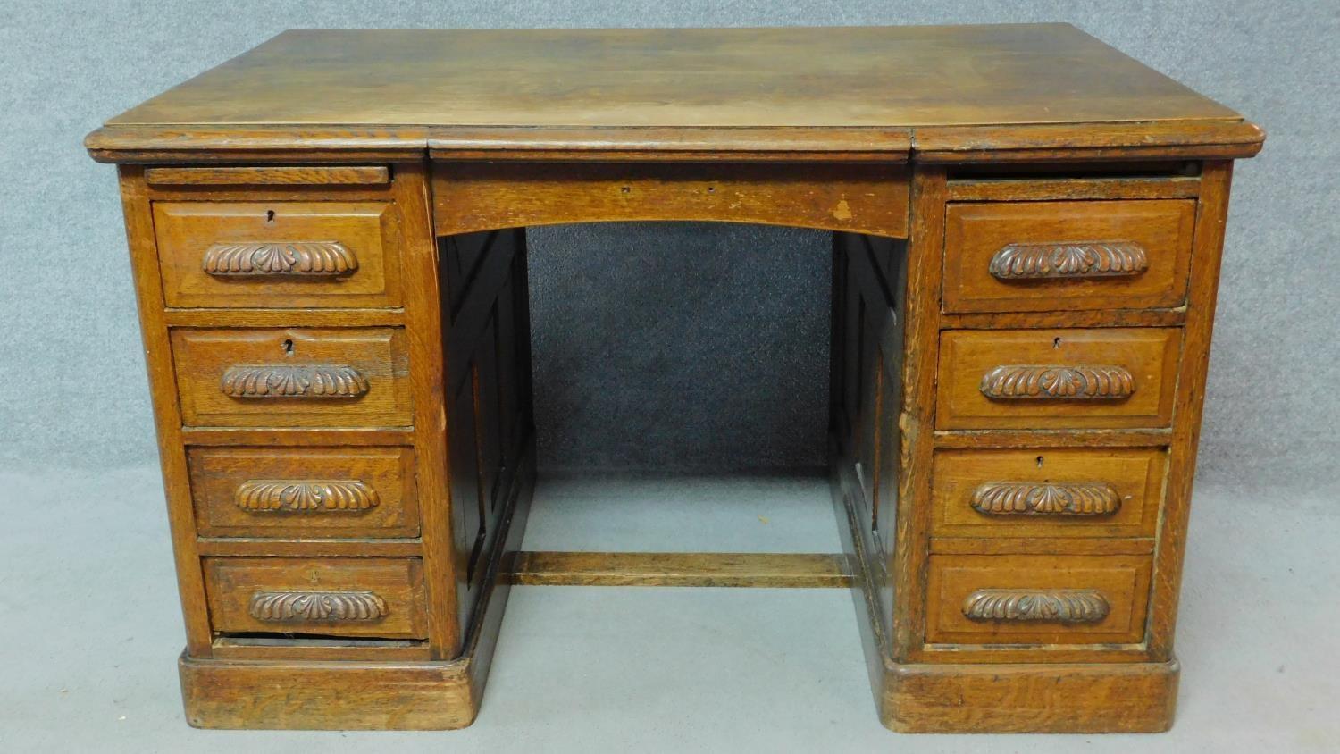 A 19th Century oak desk with eight short drawers on plinth base. H.77 W.126 D.81cm