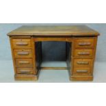 A 19th Century oak desk with eight short drawers on plinth base. H.77 W.126 D.81cm