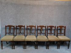 A set of six late Victorian carved walnut dining chairs raised on turned tapering supports. H.91cm