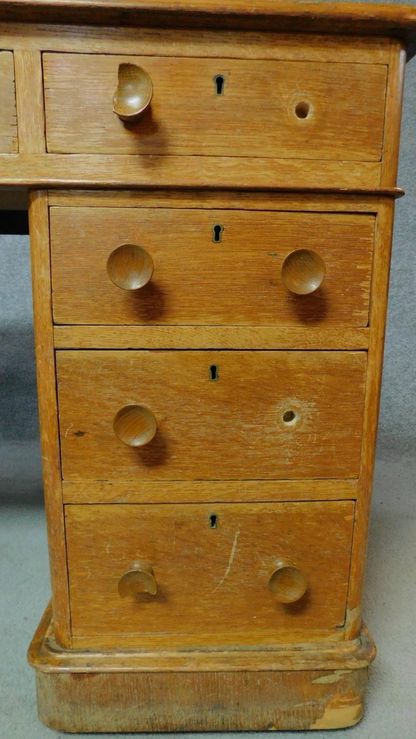 A 19th century oak leather top desk with central long frieze drawer and eight short drawers. H.75 - Image 4 of 8