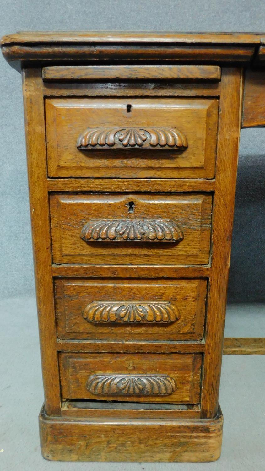 A 19th Century oak desk with eight short drawers on plinth base. H.77 W.126 D.81cm - Image 4 of 5
