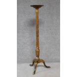 An antique giltwood torchere on turned fluted pedestal support terminating on tripod cabriole
