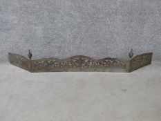 Antique pierced hinged steel and engraved fender. With dragon and urn motifs and two tapering