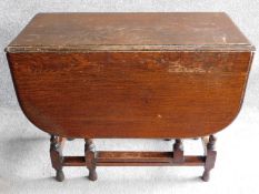 A mid 20th century oak dining table with barleytwist supports. H.72 W.122 D.90cm