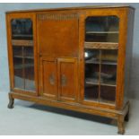 A mid 20th century carved oak bureau bookcase with central fitted secretaire section flanked by