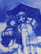 A carved gilt framed blue and white ceramic tile depicting two children under an umbrella.36x31cm