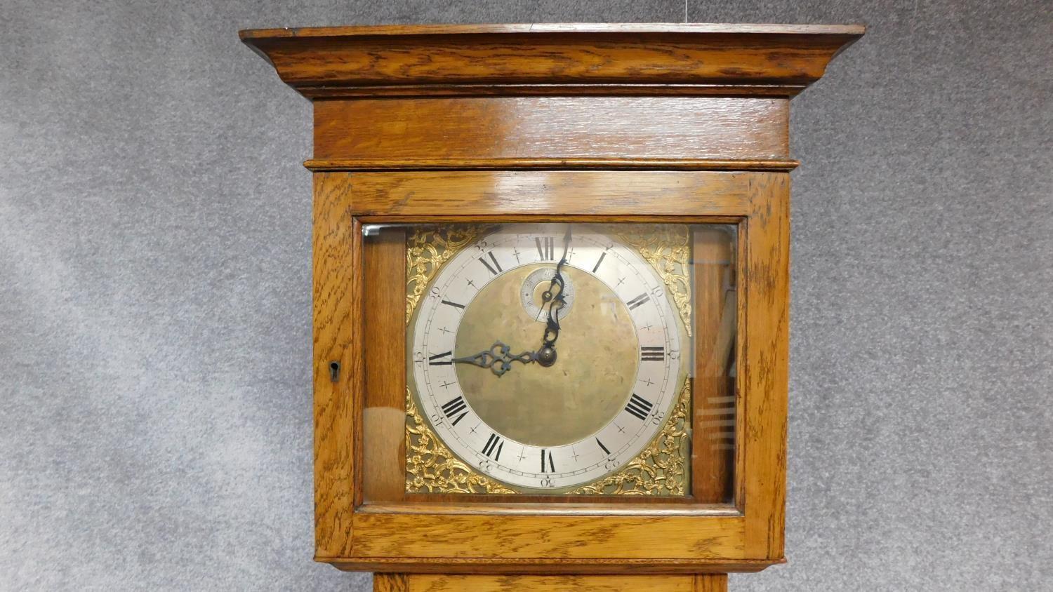 An oak cased grandfather clock, with gilded repousse detailing to the face. Black roman numerals - Image 4 of 5