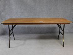 A metal framed folding trestle table H.76 L.182 W.76cm