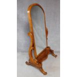 A Victorian mahogany cheval mirror with arched swing plate supported by platform cabriole base. H.
