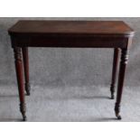 A 19th century mahogany foldover top tea table on turned tapering supports. H.74 W.45 D.92cm