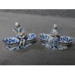 A pair of meissen blue onion pattern porcelain sweet meat dishes. One of a lady and one of a cross