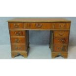 A Georgian style flame mahogany desk with long frieze drawer and eight short drawers. H.79 W.122 D.