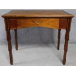 An Edwardian mahogany and satinwood strung writing table with frieze drawer on well carved supports.