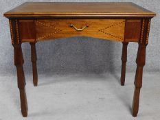 An Edwardian mahogany and satinwood strung writing table with frieze drawer on well carved supports.