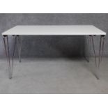 A folding trestle table on chrome supports. H.74 L.140 W.71cm